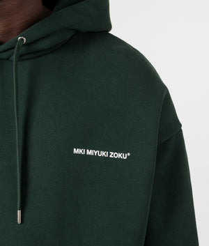 Oversized Uniform Hoodie in Green from MKI MIYUKI ZOKU. Front detail shot at EQVVS.