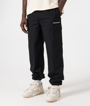 Relaxed Fit Ripstop Cargo Pants in Black by MKI MIYUKI ZOKU. EQVVS Side Model Shot.