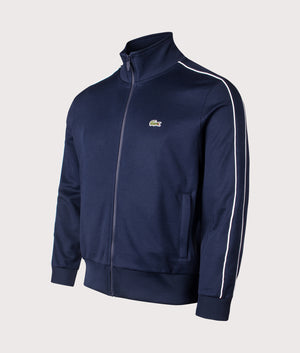 Lacoste Paris Piqué Zip Through Track Top in Navy Blue. Shot at EQVVS.  Angle shot. 