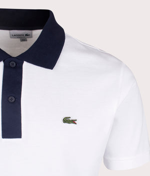 Lacoste Ribbed Collar Polo Shirt in White and Navy. Detail shot at EQVVS.