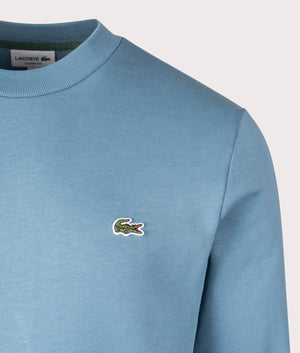 Lacoste Lacoste Relaxed Organic Brushed Cotton Sweatshirt in Limestone Blue. EQVVS Detail shot.