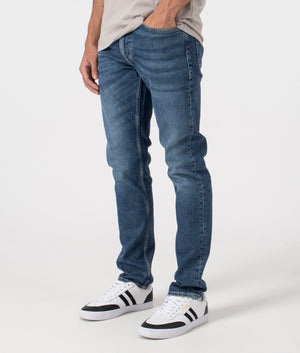 BOSS Slim Fit Delaware Comfort Stretch Jeans in Dark Blue. Side angle shot at EQVVS.