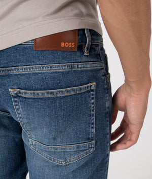 BOSS Slim Fit Delaware Comfort Stretch Jeans in Dark Blue. Back angle shot at EQVVS.