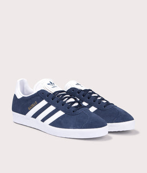 adidas Originals Gazelle trainers in Collegiate Navy/White/Gold Metallic, suede upper at EQVVS. Front pair shot. 