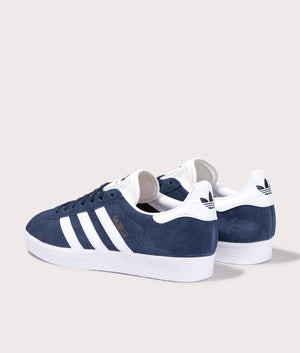 adidas Originals Gazelle trainers in Collegiate Navy/White/Gold Metallic, suede upper at EQVVS. Back pair shot. 