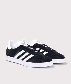 adidas Originals Gazelle Trainers in Core Black/White/Gold Metallic at EQVVS. Front pair shot. 