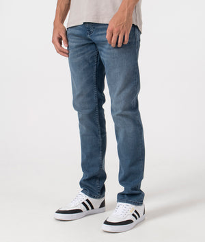 BOSS Slim Fit Delaware BC-C Jeans in Medium Blue. Front side angle model shot at EQVVS.