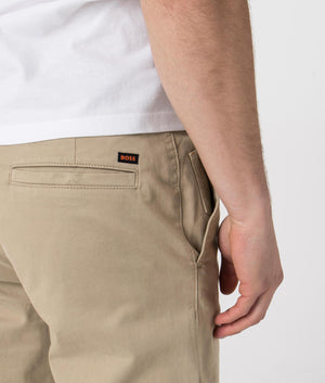 BOSS Tapered Fit Chinos in brown. Shot at EQVVS. Detail shot. 