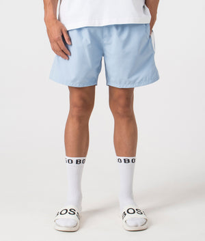 Dolphin Swim Shorts in pastel blue by BOSS. Shot at EQVVS. Front shot. 