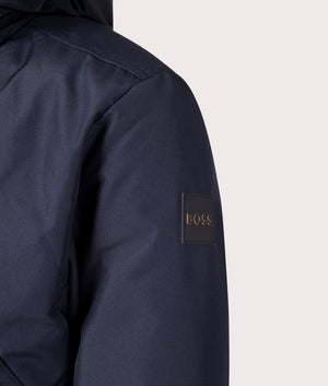 BOSS Relaxed Fit Osis Parka Jacket in Dark Blue. At EQVVS. Logo shot