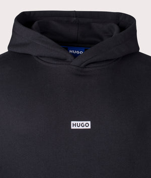 HUGO Relaxed Fit Nazardo Hoodie in black, 100% cotton at EQVVS. Detailed logo shot. 