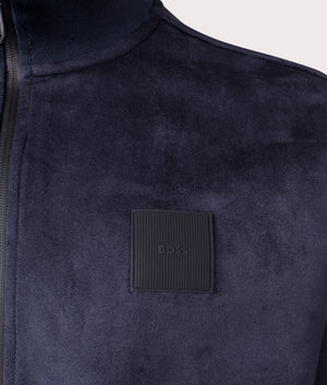 BOSS Sutton Suede Track Top in Dark Blue. Shot at EQVVS. Front logo detail 