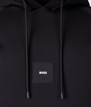 BOSS Soody Rib Hoodie in Black. Shot at EQVVS. Front logo shot