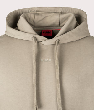 Hugo Relaxed Fit Dapo Hoodie in Medium Brown. Shot at EQVVS. Front logo shot 