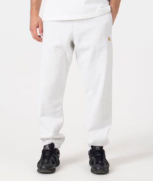 Carhartt WIP Relaxed Fit Chase Joggers in Ash Heather/Gold. Front angle model shot at EQVVS.