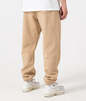 Carhartt WIP Relaxed Fit Chase Joggers in Sable/Gold. Back angle model shot at EQVVS.