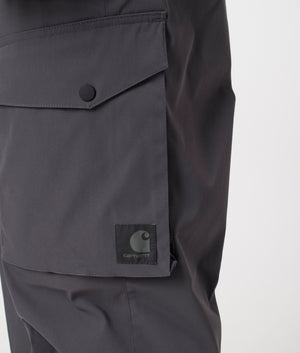 Carhartt WIP Relaxed Fit Balto Cargo Pants in Graphite at EQVVS Menswear logo detail shot