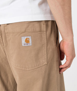 Carhartt WIP Relaxed Fit Floyde Pants in Leather. Detail angle model shot at EQVVS.