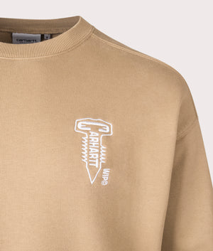 Carhartt WIP Oversized Cross Screw Sweatshirt in Peanut, 100% cotton at EQVVS. Logo detail shot. 