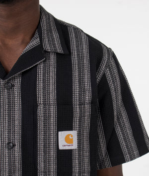Carhartt WIP Short Sleeve Dodson Shirt in Black. Detail angle model shot at EQVVS.