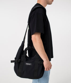 Carhartt WIP Medium Kayton Bag in Black. Side angle model shot at EQVVS.