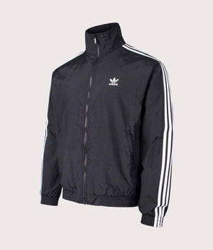 Relaxed Fit Adicolor Classics Firebird Track Top in Black by adidas Originals at EQVVS. Side Angle Shot. 