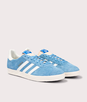 adidas Originals Gazelle Trainers in Light Blue/Off White/Cream White at EQVVS. Front pair shot. 