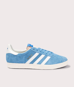 adidas Originals Gazelle Trainers in Light Blue/Off White/Cream White at EQVVS. Solo side shot. 