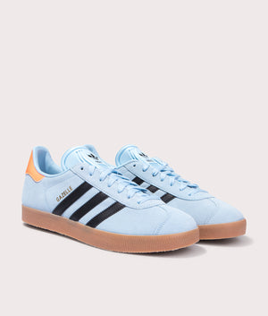 adidas Originals Gazelle trainers in Clear Sky/Core Black/Gum 2 at EQVVS. Front pair shot. 