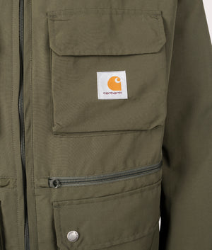 Carhartt WIP Irwin Jacket in Turtle at EQVVS. Detailed logo shot. 