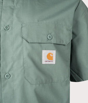 Carhartt WIP Relaxed Fit Craft Shirt in Silver Pine at EQVVS. Detailed logo shot.