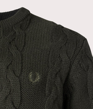 Fred Perry Chunky Cable Knit Jumper in 408 Hunting Green, Lambswool/Recycled Polyamide. At EQVVS Menswear. Front logo shot