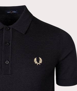 Fred Perry Classic Knitted Polo Shirt in Black, 54% Merino Wool, 46% Cotton at EQVVS. Detailed logo shot. 