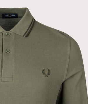 Fred Perry Long Sleeve Twin Tipped Polo Shirt in Laurel Wreath Green, 100% Cotton at EQVVS Menswear. Deatiled logo Shot. 