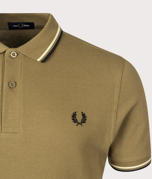 Fred Perry Twin Tipped Polo Shirt in Shaded Stone, 100% Cotton at EQVVS Menswear. Detail logo shot. 