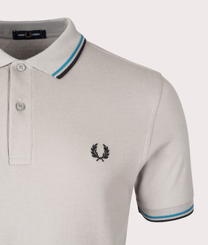 Fred Perry Twin Tipped Polo Shirt in Limestone, 100% Cotton at EQVVS. Detailed logo shot. 