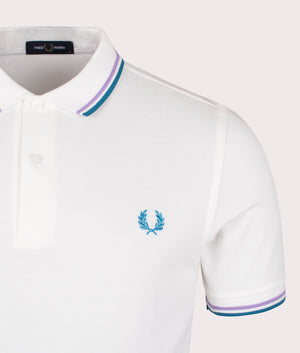 Fred Perry Twin Tipped Polo Shirt in Snow White, 100% Cotton at EQVVS. Detail logo shot. 