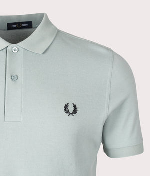 Fred Perry Polo Shirt in Silver Blue/ Black, 100% Cotton at EQVVS. Detail logo shot. 