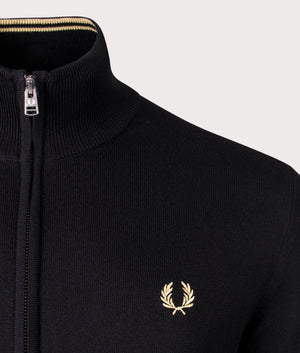 Fred Perry Classic Zip Through Cardigan in black, 54% Merino Wool, 46% Cotton at EQVVS. Detailed logo shot. 