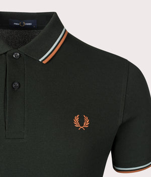 Fred Perry Twin-tipped Polo Shirt in Night Green, 100% Cotton at EQVVS. Detailed log shot .