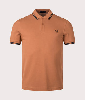 Fred Perry Twin Tipped Polo Shirt in Marmalade. Shot at EQVVS. Front shot. 