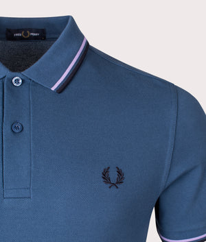 Fred Perry twin-tipped polo in midnight blue, 100% cotton at EQVVS. Detailed logo shot. 