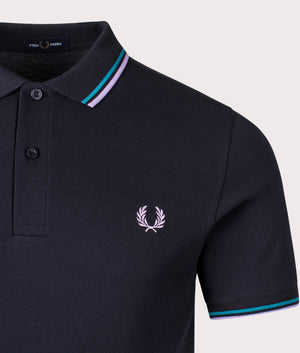 Fred Perry Twin-Tipped Polo Shirt in Navy, 100% Cotton  at EQVVS. Detailed logo shot. 