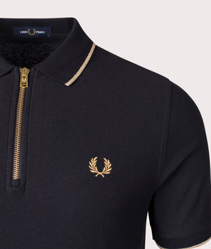 Fred Perry Crepe Pique Zip Neck Polo Shirt in black, 100% Cotton at EQVVS. Detailed logo shot. 