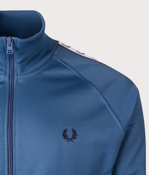 Fred Perry Zip Through Taped Track Top in Midnight Blue at EQVVS. Detailed Logo Shot. 