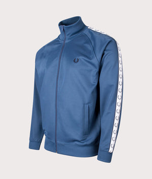 Fred Perry Zip Through Taped Track Top in Midnight Blue at EQVVS. Side Shot of Arm Detailing. 