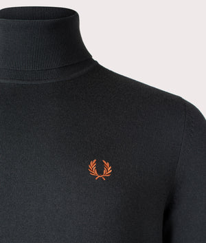 The Fred Perry Roll Neck Jumper in Night Green. Detail angle shot at EQVVS.