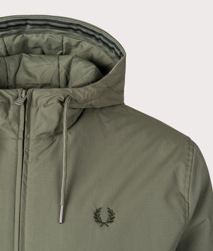 Fred Perry hooded Brentham Jacket in Laurel Wreath Green at EQVVS. Detailed Logo Shot. 