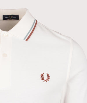 Fred Perry Long Sleeved Twin Tipped Polo Shirt in Light Ecru/Silver Blue/Cinnamon, 100% cotton at EQVVS. Detailed logo shot. 