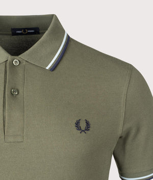 Fred Perry Twin Tipped Polo Shirt in Laurel Wreath Green / Tennis Blue. Shot at EQVVS. Detail shot. 